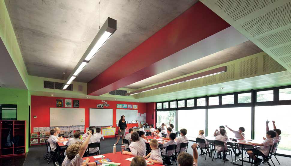 Downstairs the bright green and red palette is more grounding for the Year 5 boys, and offsets the hard brick and concrete.