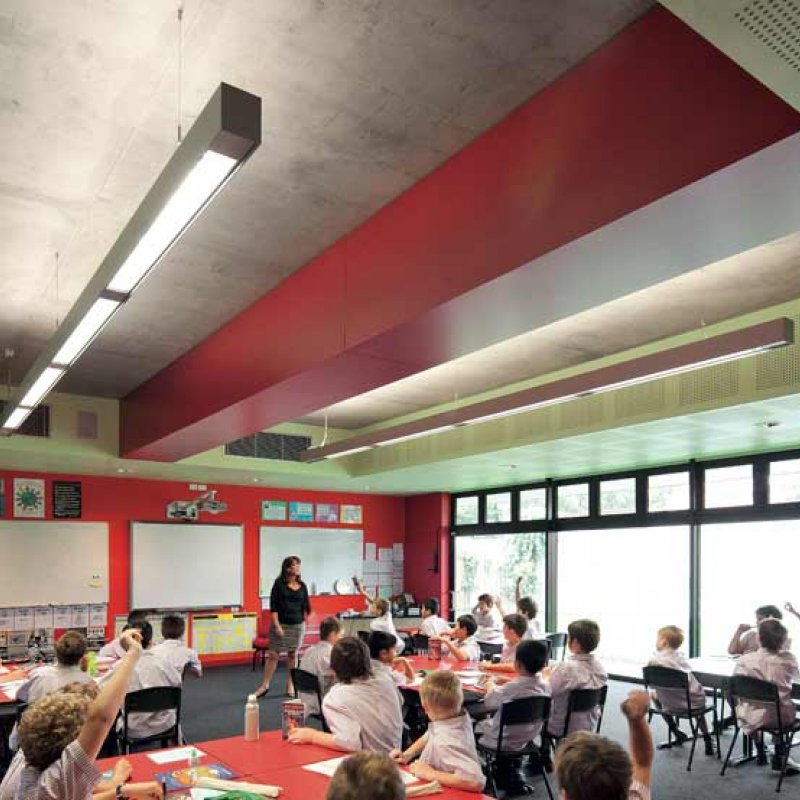 Downstairs the bright green and red palette is more grounding for the Year 5 boys, and offsets the hard brick and concrete.